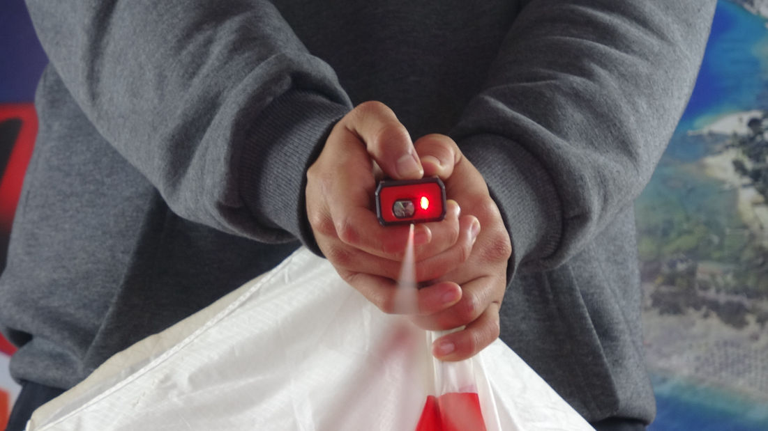 Repairing red and blue paraglider