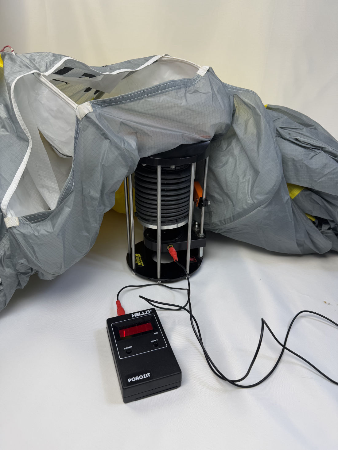 Testing the fabric of grey paraglider with hello porosity fabric permeability tester