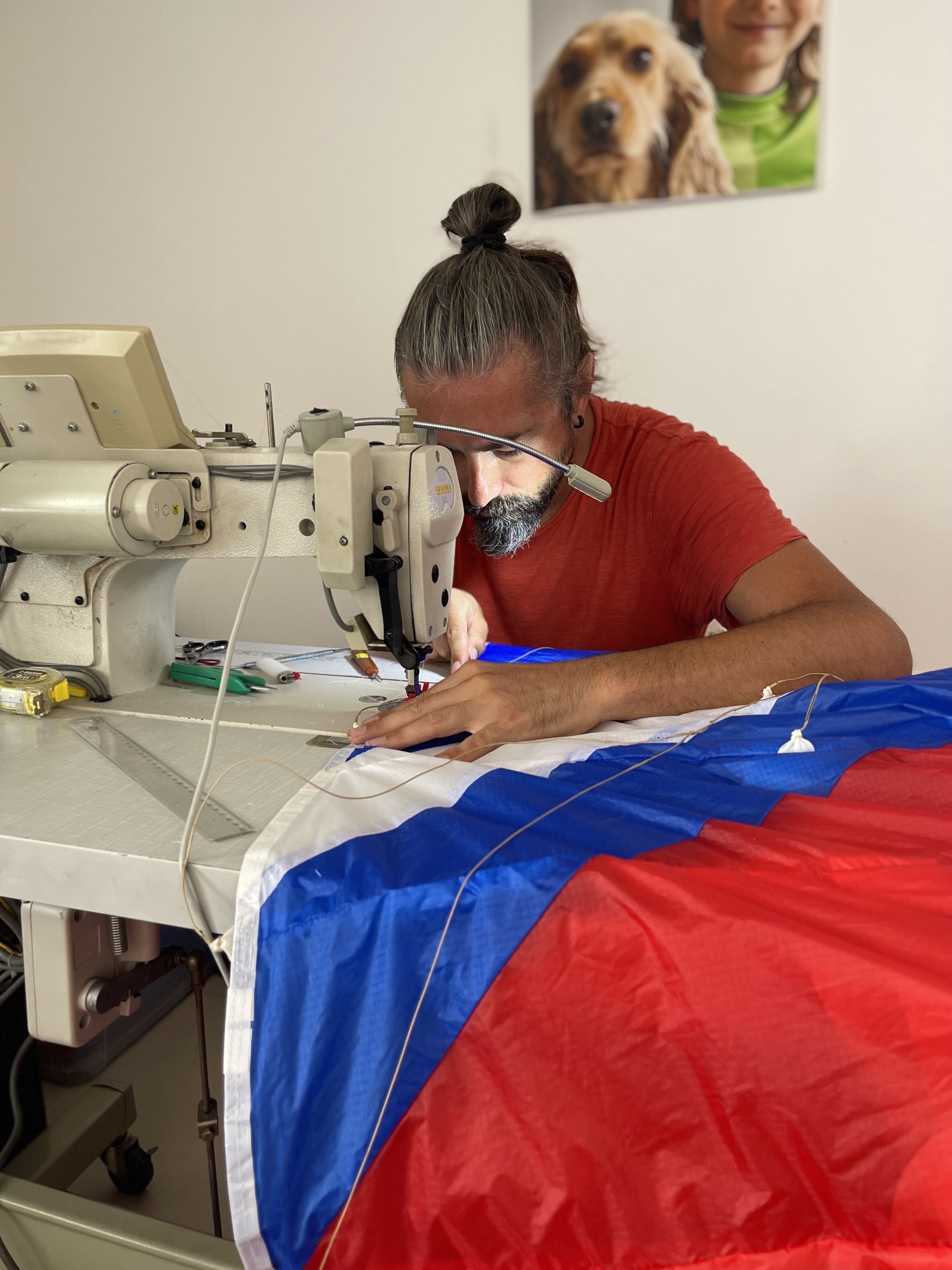 Repairing red and blue paraglider