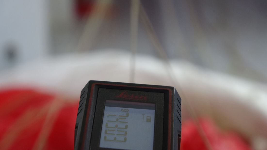 Measuring paraglider line with laser.